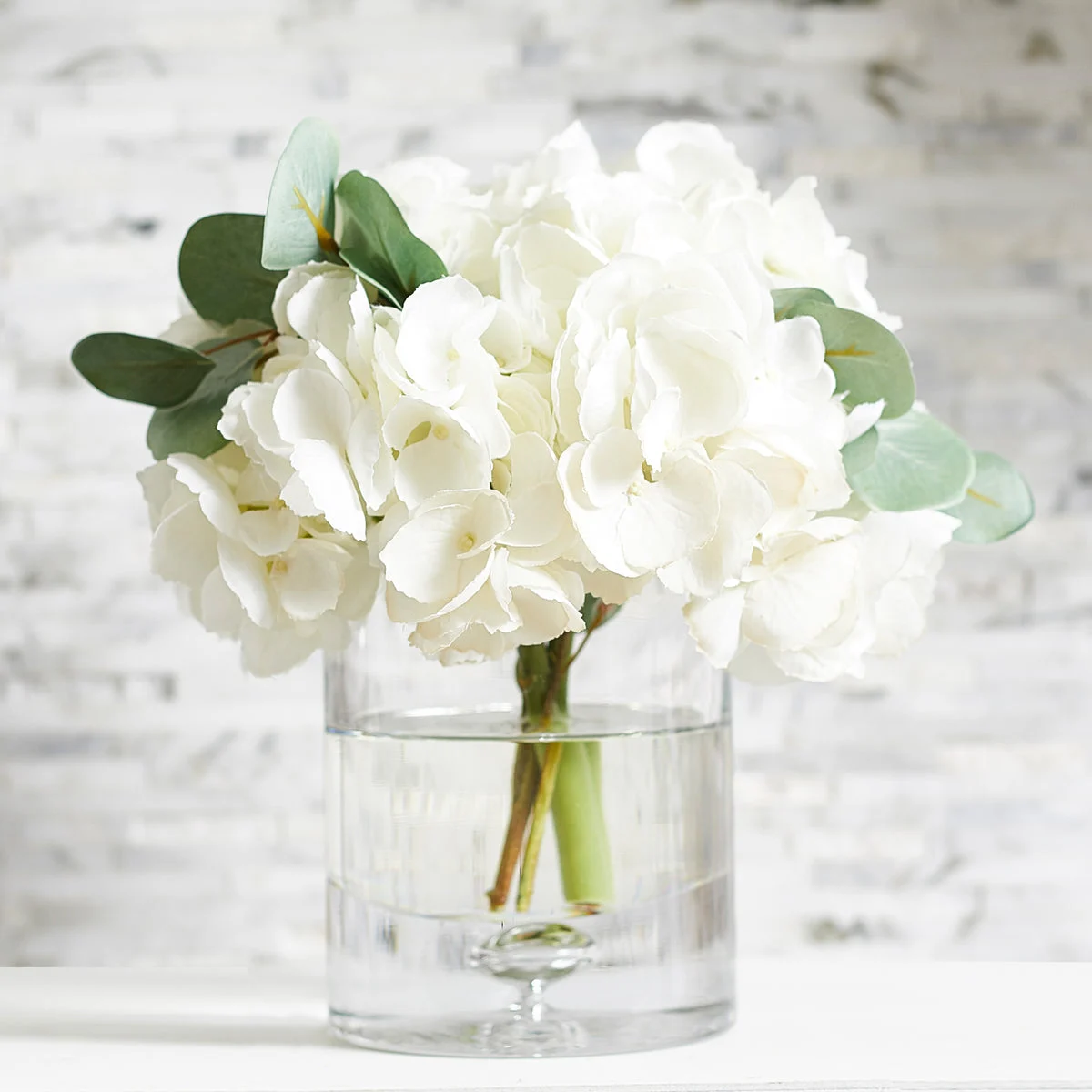 White Hydrangea & Eucalyptus Arrangement in Glass Cylinder Vase